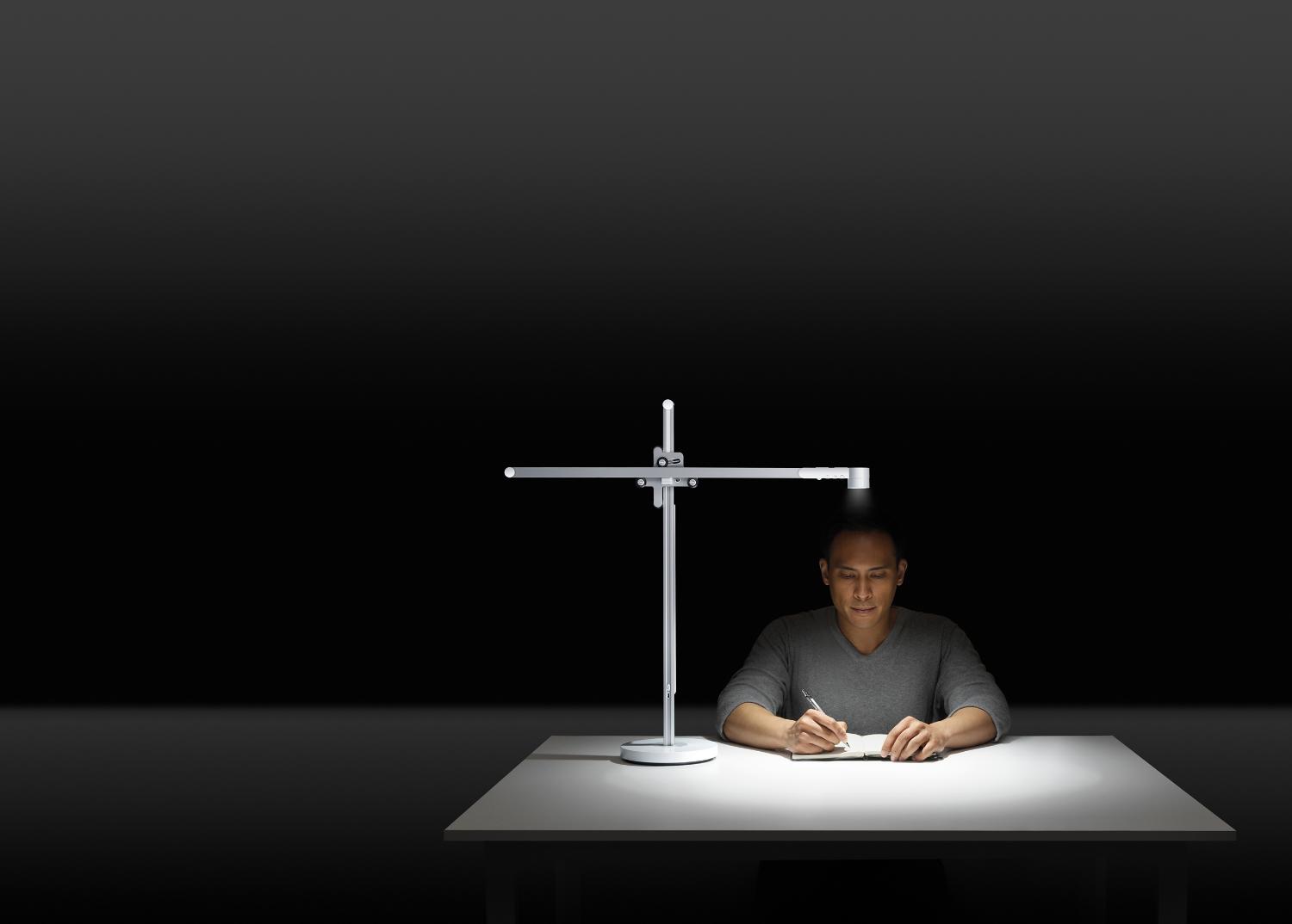 man studies under Dyson Lightcycle task light